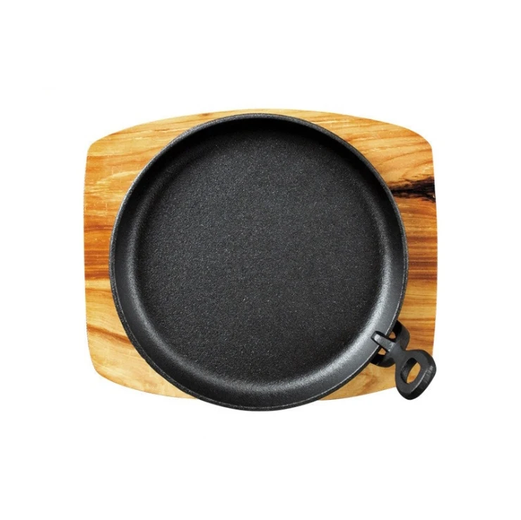 Cast iron frying pan with wooden board