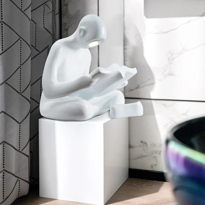 
Figurine manufacturers kid reading human sculpture for library 