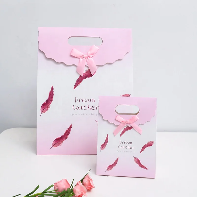 
New feather pattern clamshell high-end fashion clothing shopping tote bag gift white card paper bag customization spot 