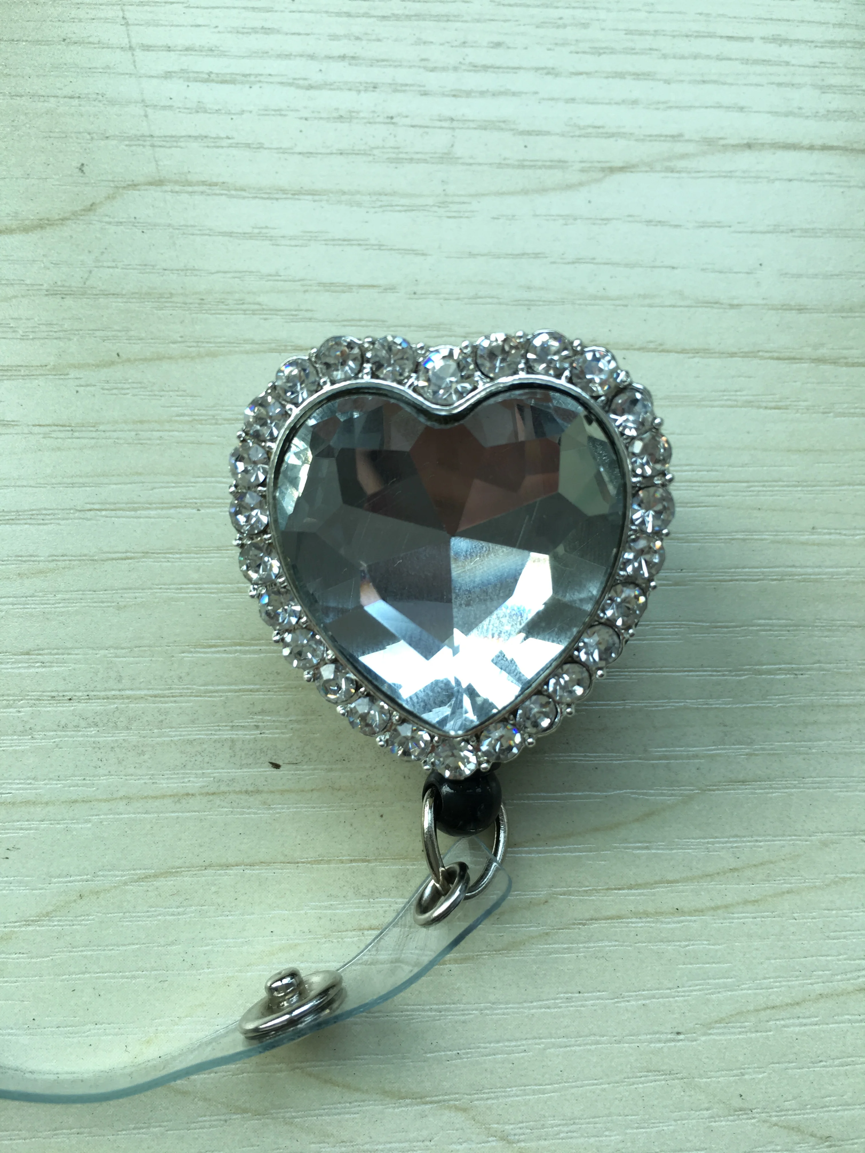 Retractable reel badge with breast cancer awareness logo