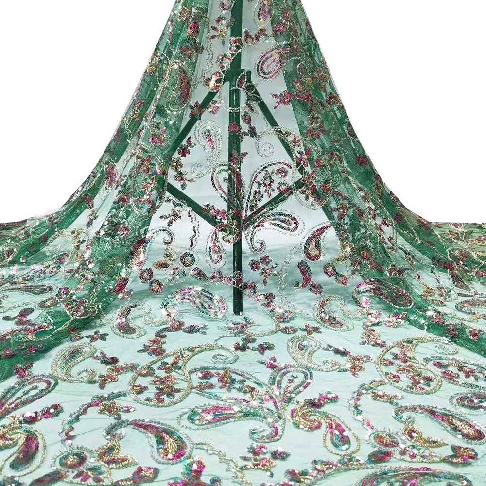 The most luxurious and beautiful green peacock feather sequin beaded embroidery fabric in Nigeria is used for stage clothes