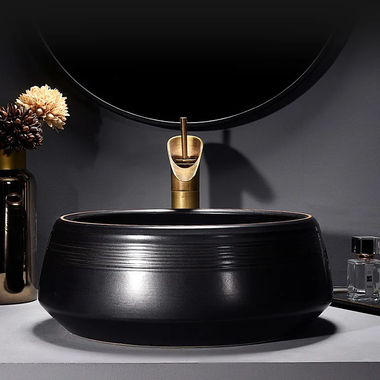 China Artistic Handmade Ceramic Wash Basin Round Counter Top Porcelain Sinks Carved Black Bathroom Sinks