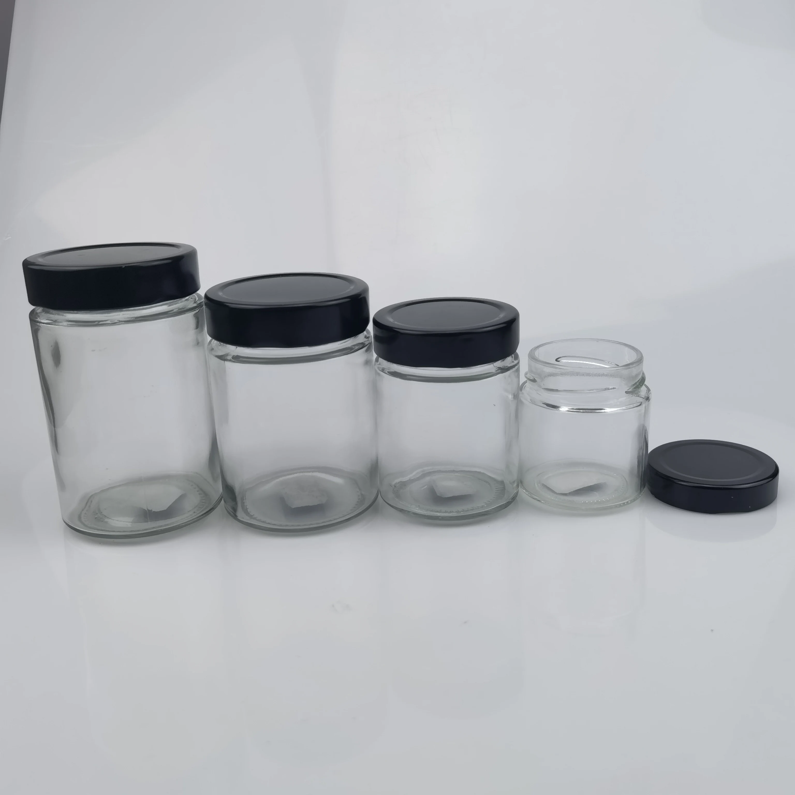 Factory price 100ml 140ml 180ml 200ml 220ml 280ml 212ml Round Shape Ergo Honey Glass Jar with Twist Metal Lid