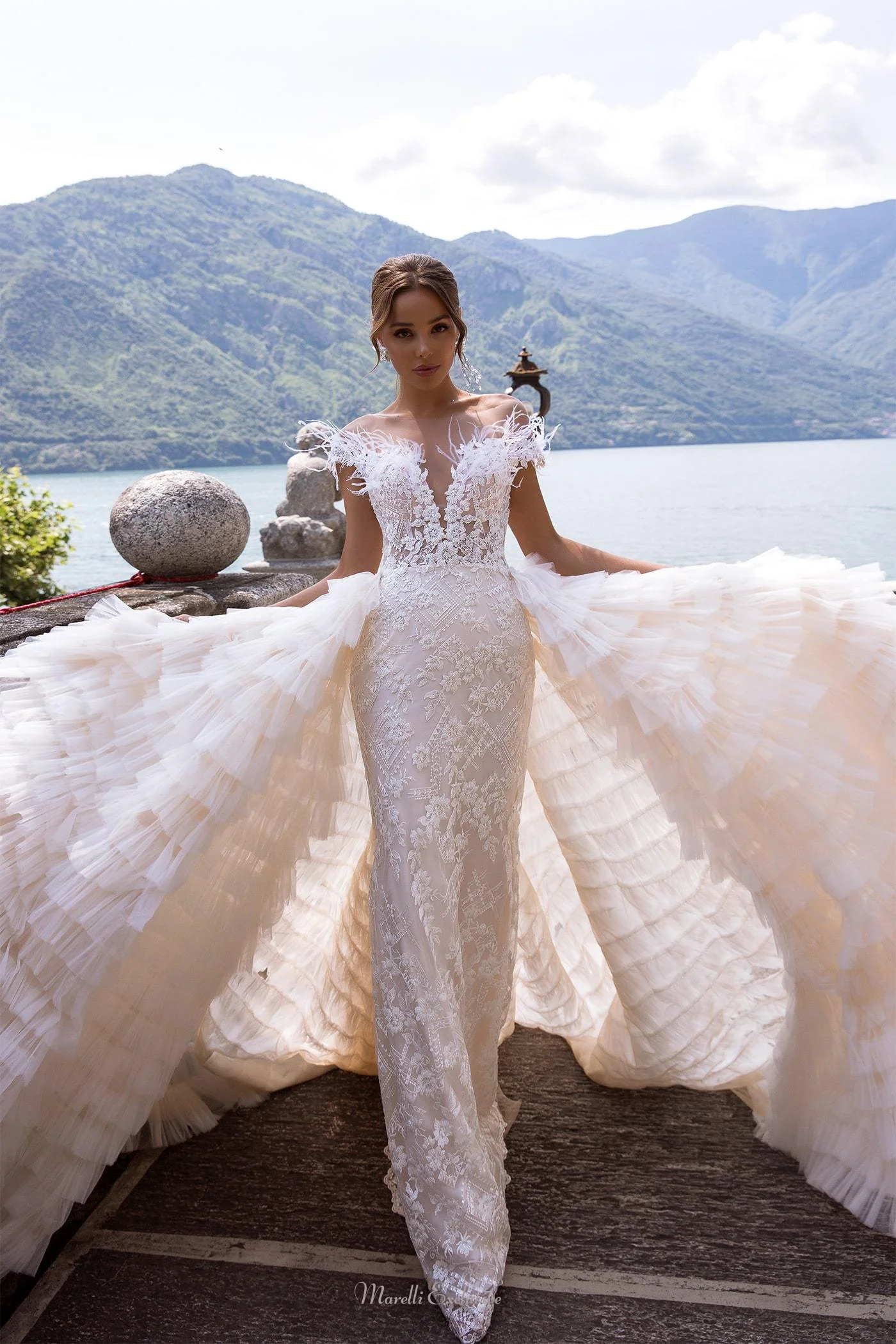 A tight-fitting long tail wedding dress with a removable tulle train created by layers of tulle Decorated swan feathers