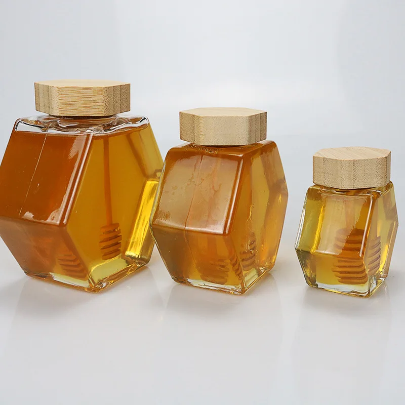 Wholesale 100ml 220ml 380ml Unique Hexagonal Glass Bottle Jar  For Honey with Wooden Lids and Dipper
