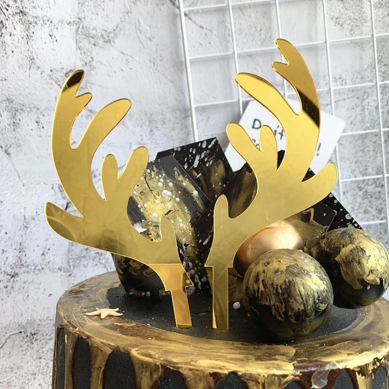 A pair of gold elk acrylic Christmas cake topper for cake decoration
