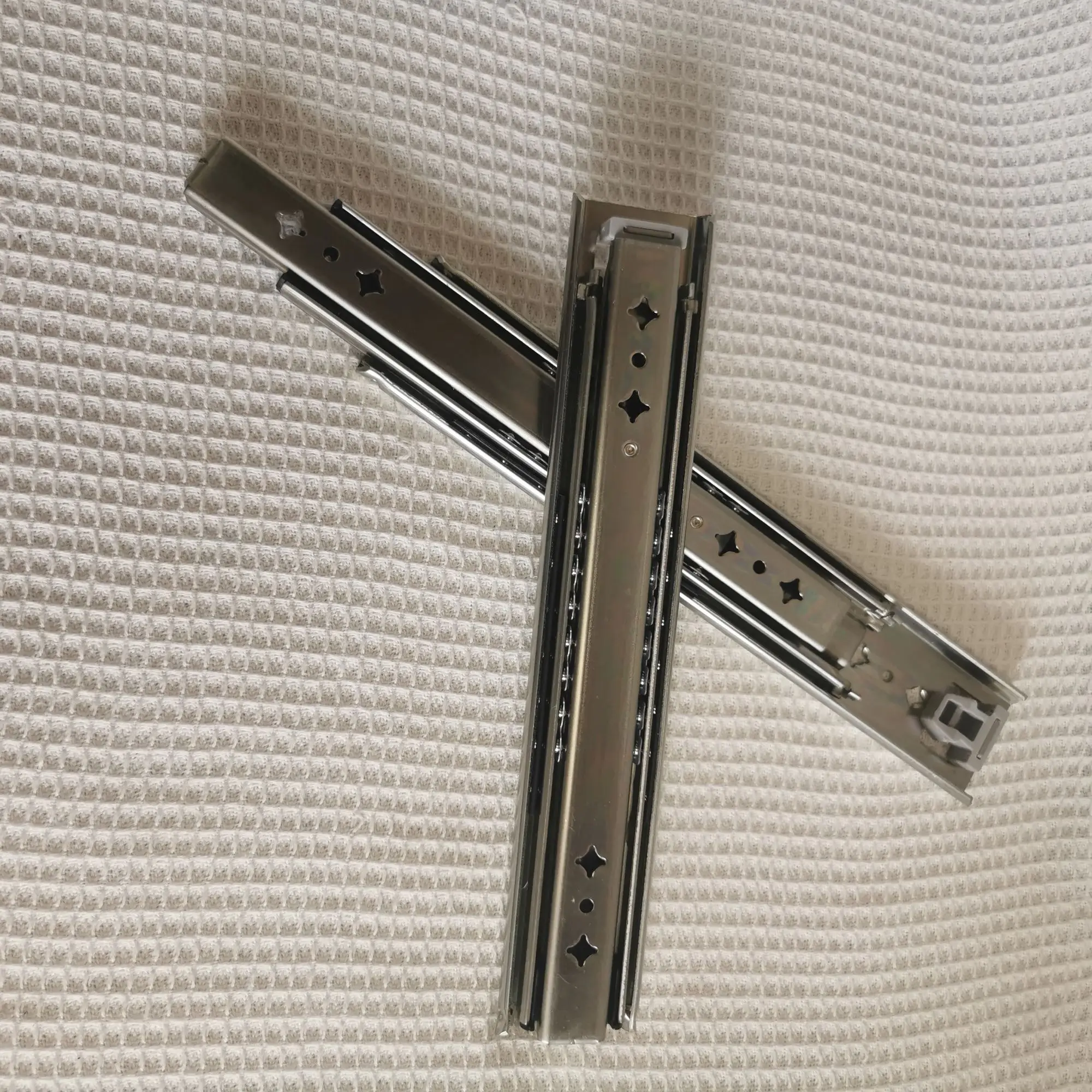 Hidden drawer slides are installed at the bottom of the heavy-duty drawer rails under the stairs