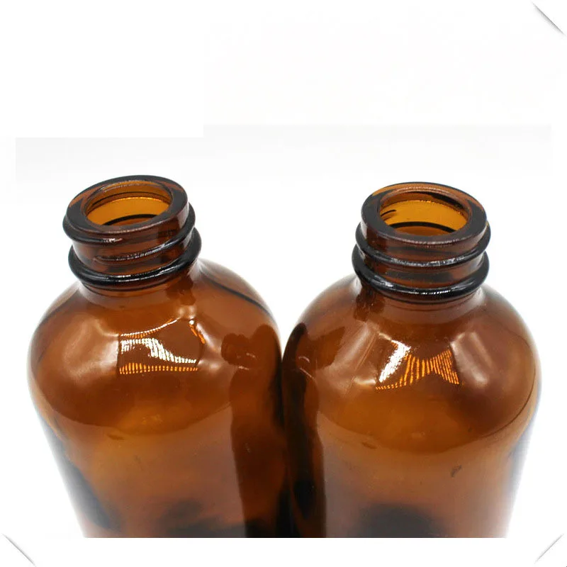 
4OZ empty amber boston round glass bottle with black round cap 