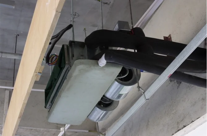 Ceiling mounted heating and cooling fan coil