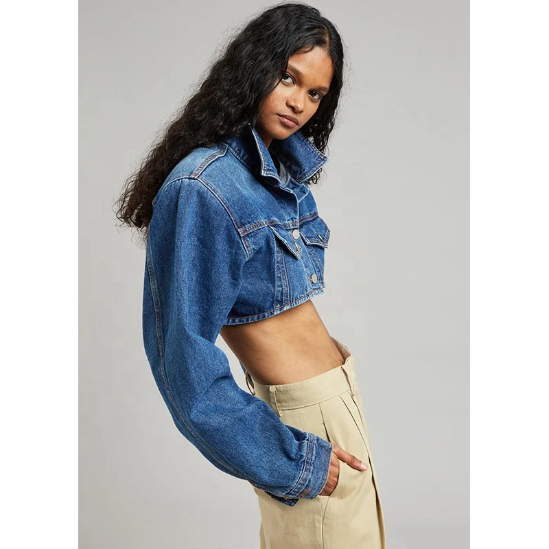 Dark Indigo Lightweight cotton denim Highly cropped profile Padded shoulders Flap front pockets Button front closure Denim jack