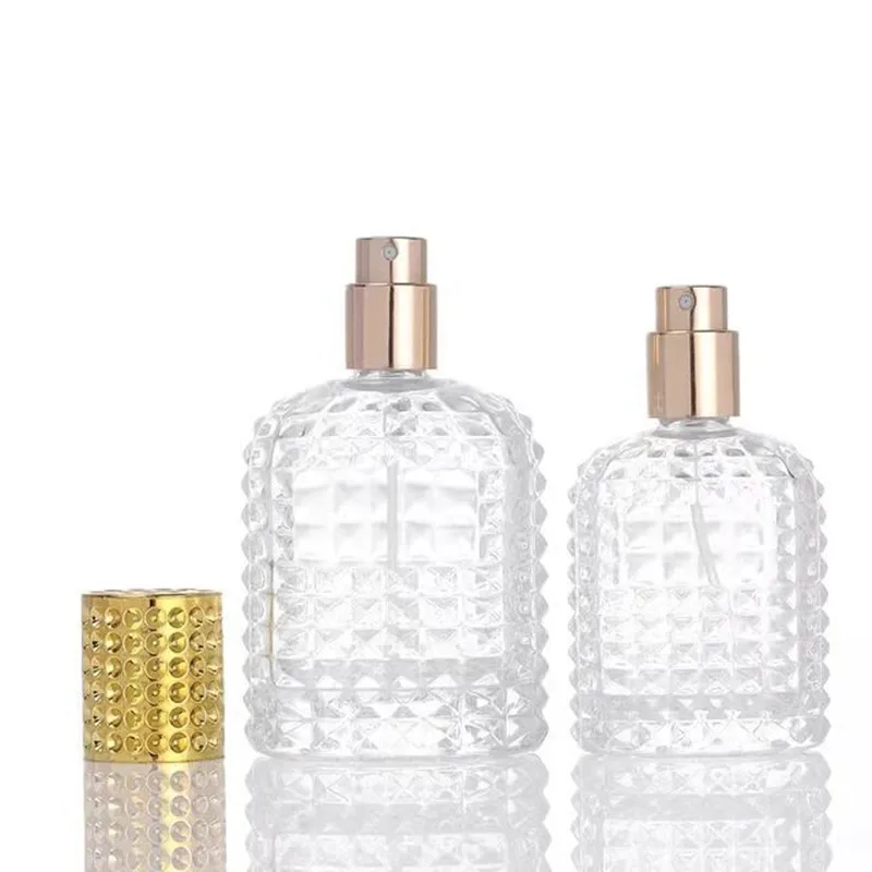 Hot Selling Transparent Perfume Spray Bottle Glass 50ml 100ml Unique Shape Perfume Packing Bottles with Gold Cover YGJ-070