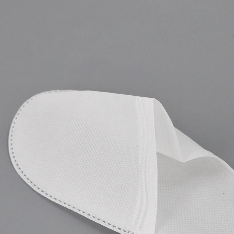Wholesale cheap price non-woven fabric disposable slippers eco friendly sole spa and hotel slippers