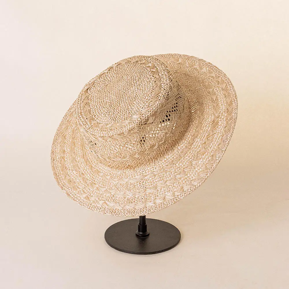 Fashion hand braided pattern hollowed out flat top beach hat unisex outdoor sunscreen natural sisal straw boater hat wholesale