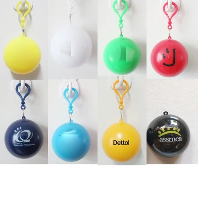 P722  Custom Logo Hotel Cape Rain Coat Portable Outdoor Disposable Raincoat With Keychain Waterproof Ball Capsule PE Raincoats