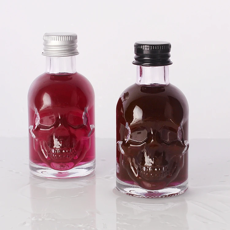 Wholesale 50ml Skull shape small sample alcoholic beverage bottle glass wine bottle with lids
