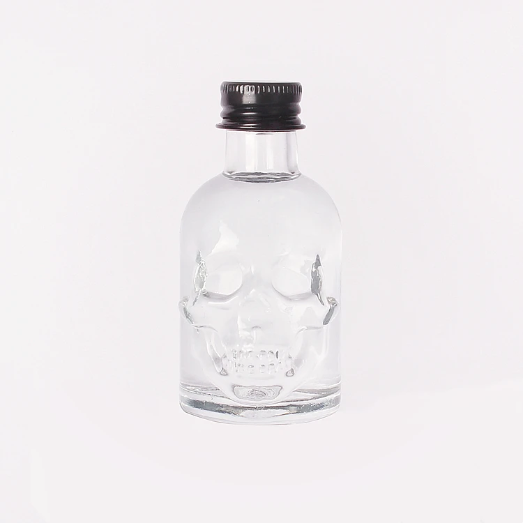 Wholesale 50ml Skull shape small sample alcoholic beverage bottle glass wine bottle with lids