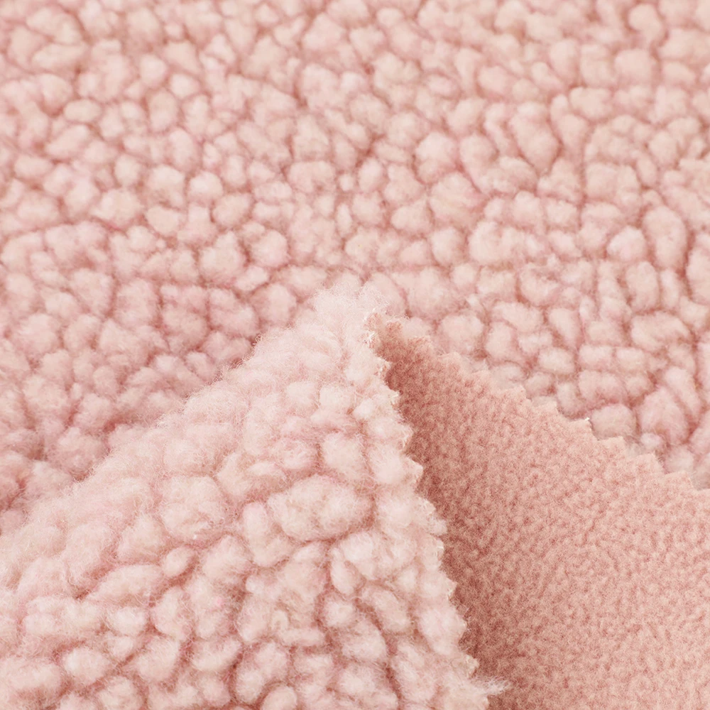 Hot selling winter warm thick polyester solid super soft flannel plush fabric for pajamas