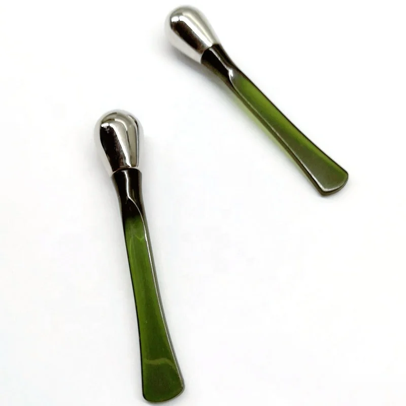 Luxury golden metal spatula in cosmetic along with skincare cream jars