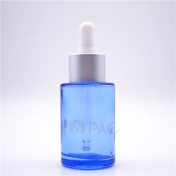 1 ounce cosmetic flat shoulder colored blue glass oil bottle with dropper