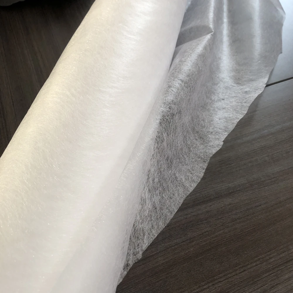 Hot melt adhesive web used for bonding fabrics together