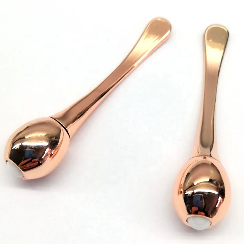 Luxury golden metal spatula in cosmetic along with skincare cream jars