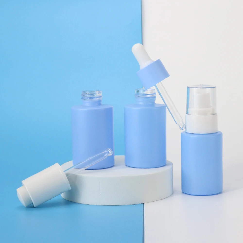 Wholesale 1oz empty blue round skin care glass bottle packaging cosmetic body oil bottle lotion bottle with pump cap 30ml