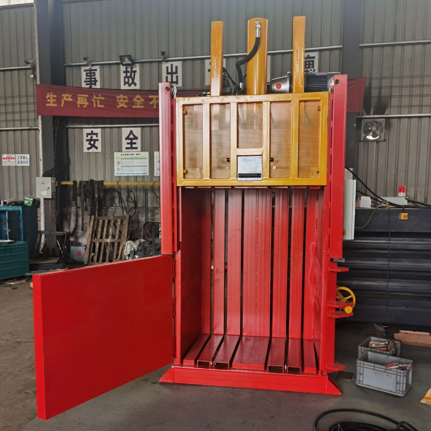 Vertical cardboard baler designed for recycling waste cardboard, cartons and newspaper with wide feed opening door