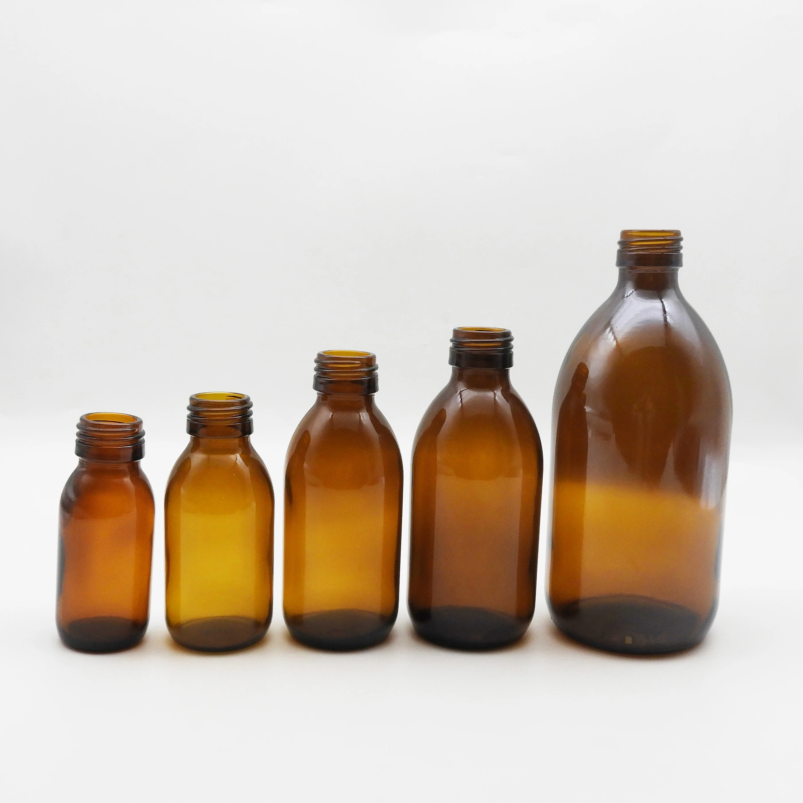 Wholesale 30ml-500ml cosmetic clear amber  round glass bottle for liquid medicine