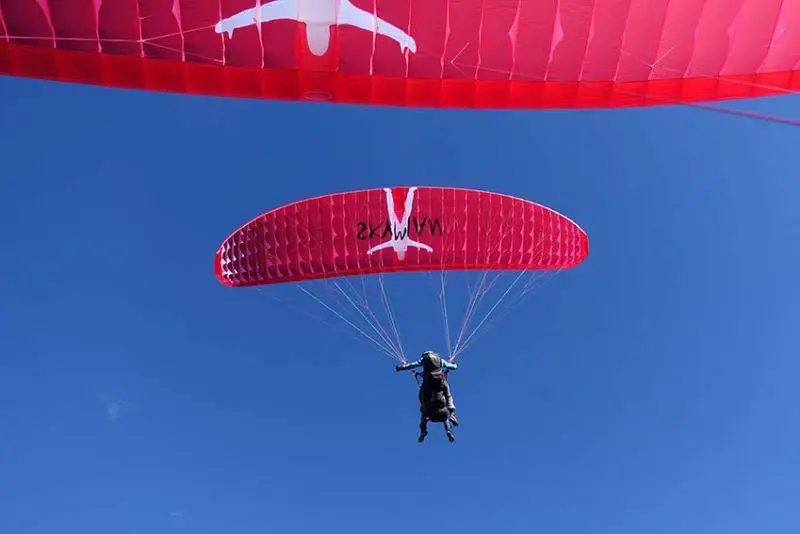 The orange remote-controlled sports aircraft paramotor can be used by two people.