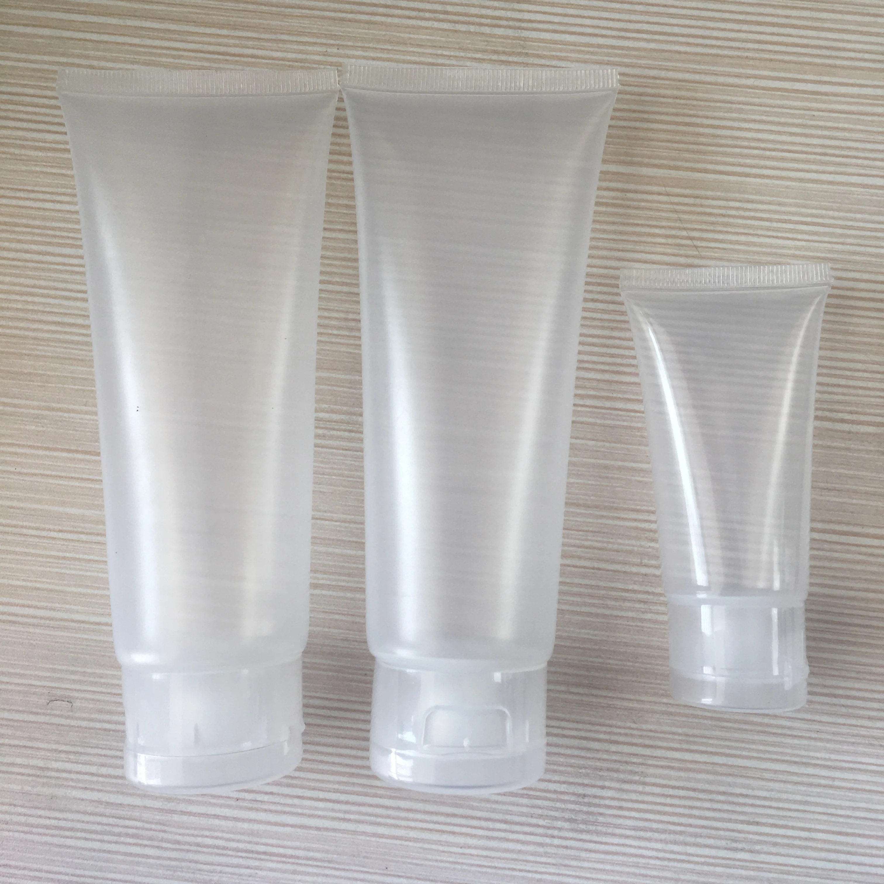 Empty 20ml 30ml 50ml 100ml transparent plastic tube flip top face wash cream soft tubes for cosmetic packaging