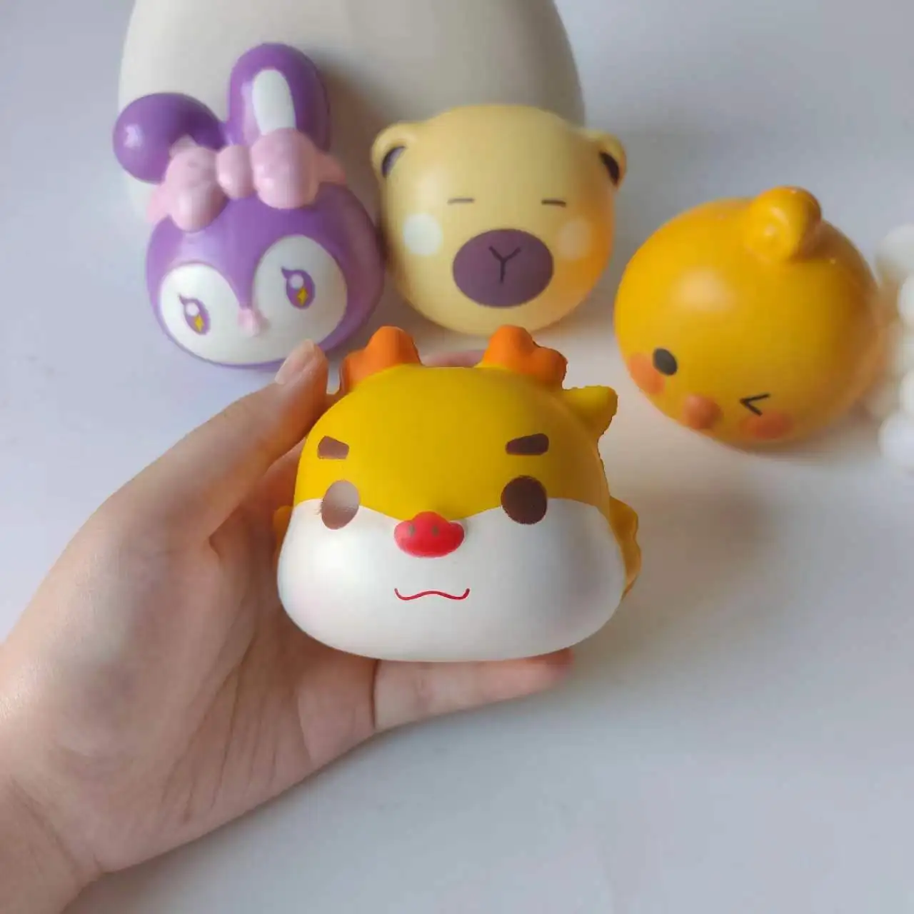 Wholesale hot selling relief popular animal head elastic rabbit chicken dragon kids squeeze PU slow rebound fidget toy