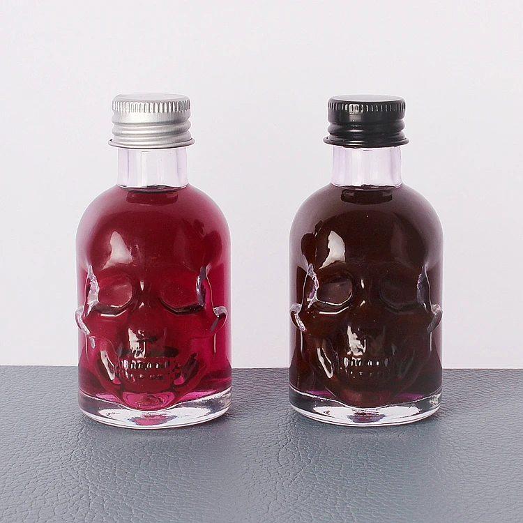 Wholesale 50ml Skull shape small sample alcoholic beverage bottle glass wine bottle with lids