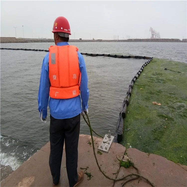 floating rubber oil spill containment boom on the sea