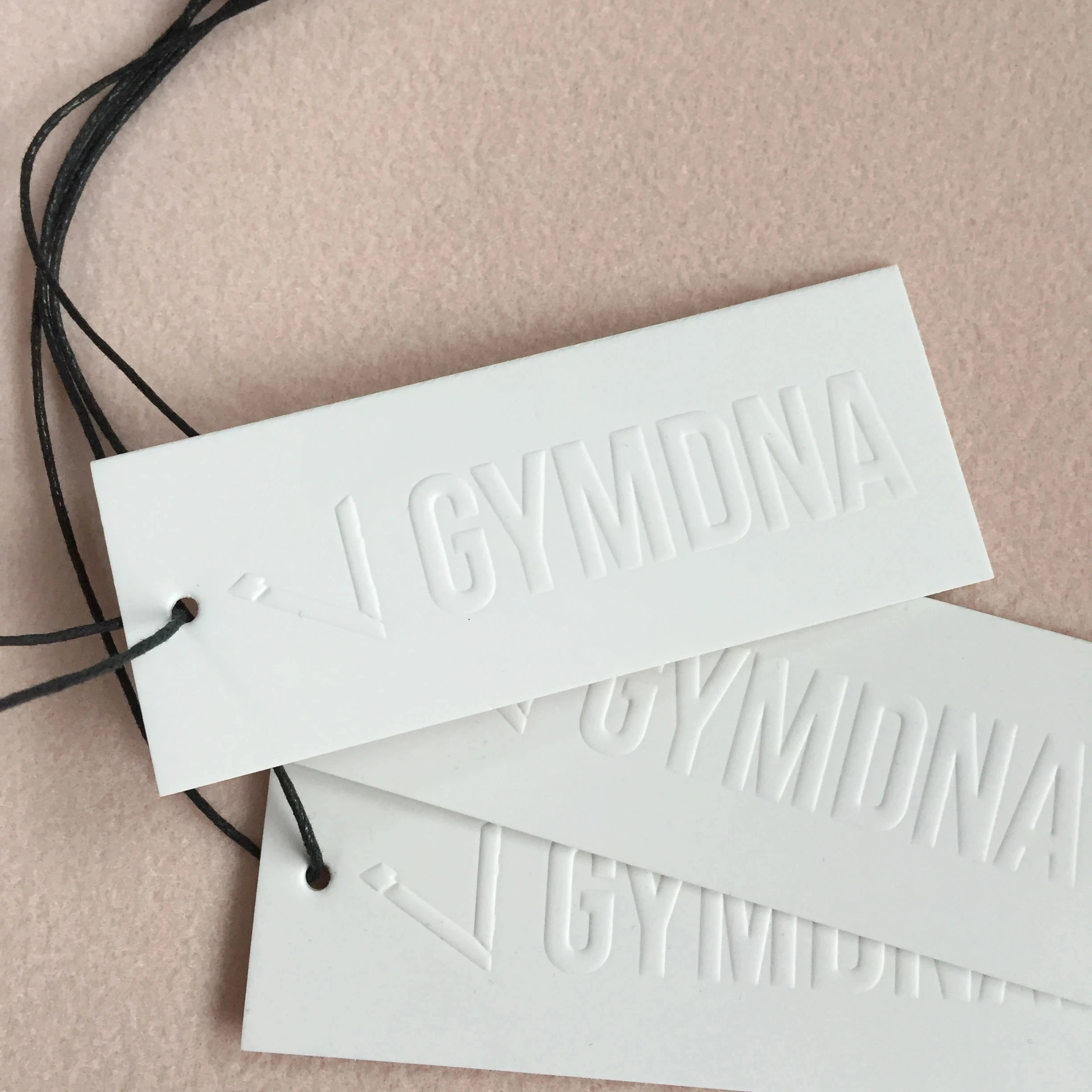 Eco friendly Custom Embossed Debossed Brand Logo White Pape Swing Hang Tag With Hangtag String