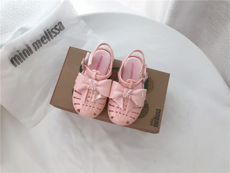 2023 mini Melissa shoes kid bowknot hollow out sandal jelly baby wrap toe soft sole beach wear resistant skid shoes