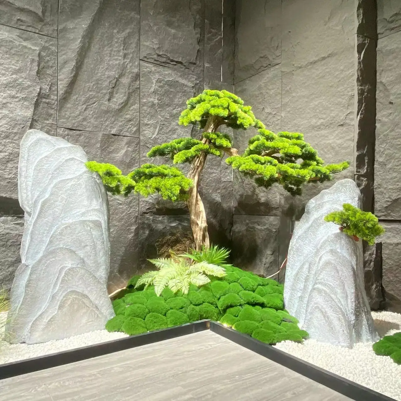 Garden Landscaping & Decking with Artificial plants and small white stones