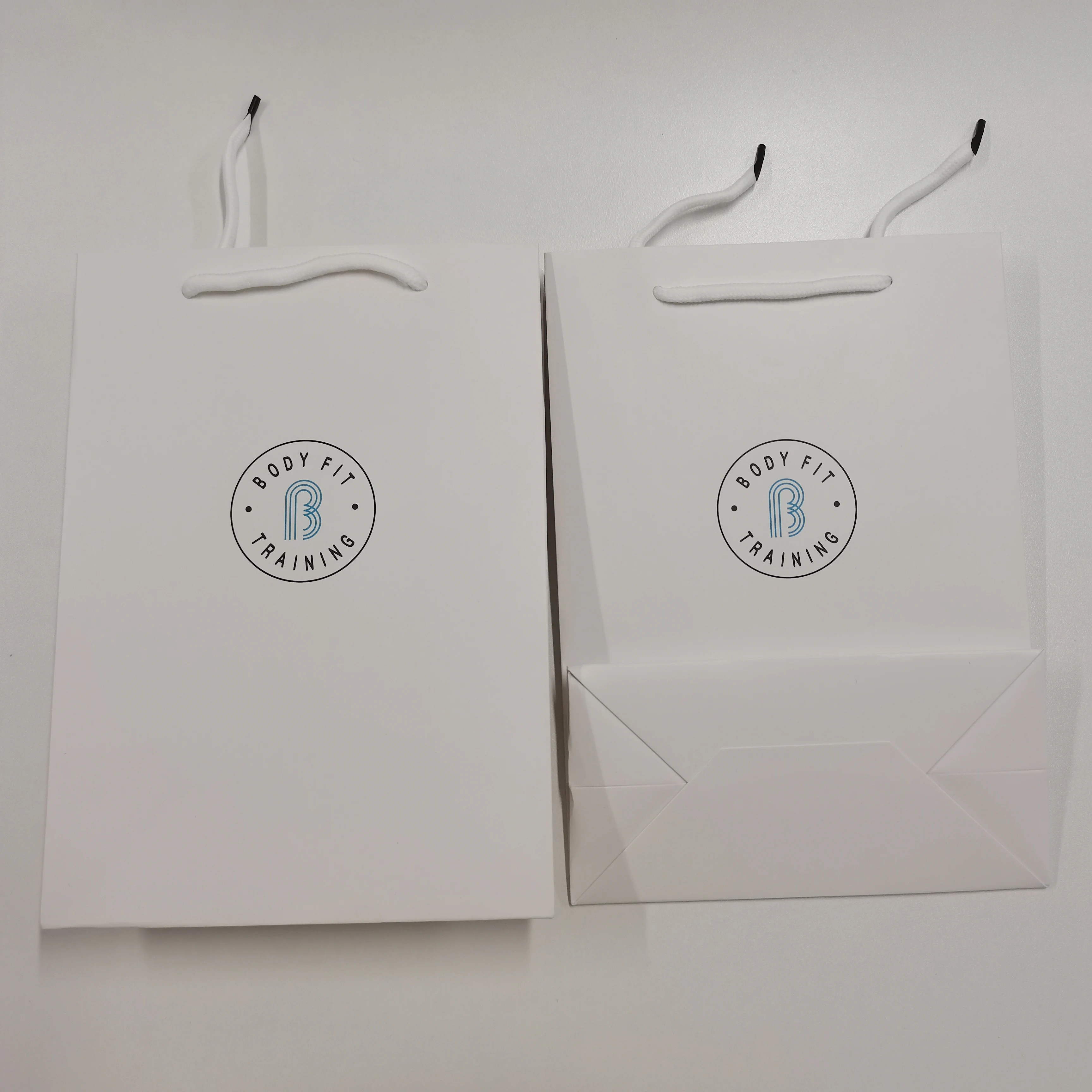 Wholesale custom printed black luxury shopping gift paper bag with handle and bow ,luxury paper bags with your own logo