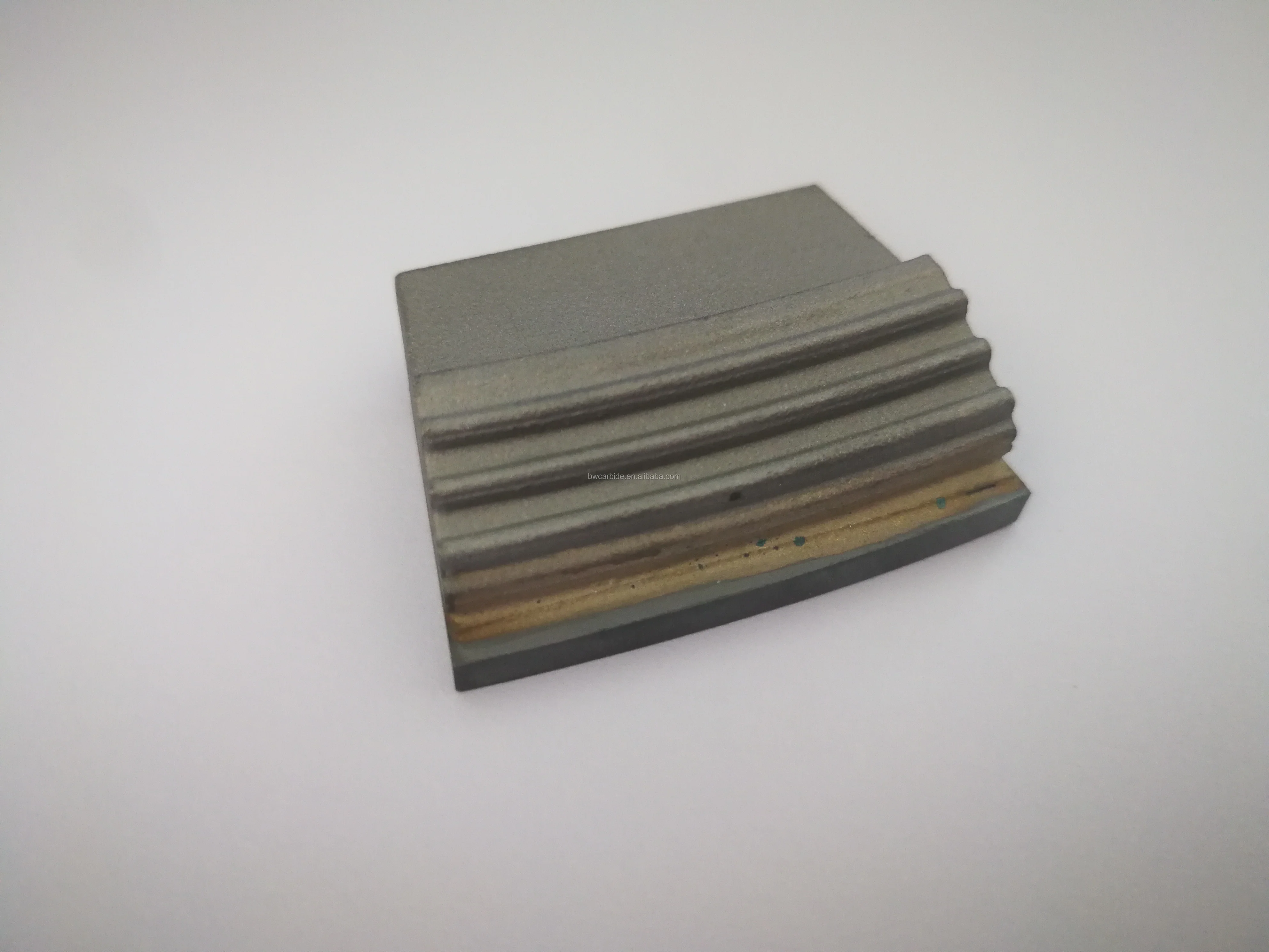 Decanter centrifuge wear tiles with good wear resistance