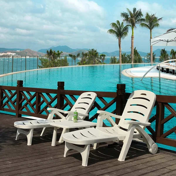 Outdoor beach hotel swimming pool plastic chaise lounge chair