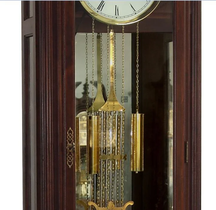 Floor Grandfather Clock door flanked by twin canted columns with turned top and bottom caps completing the traditional de