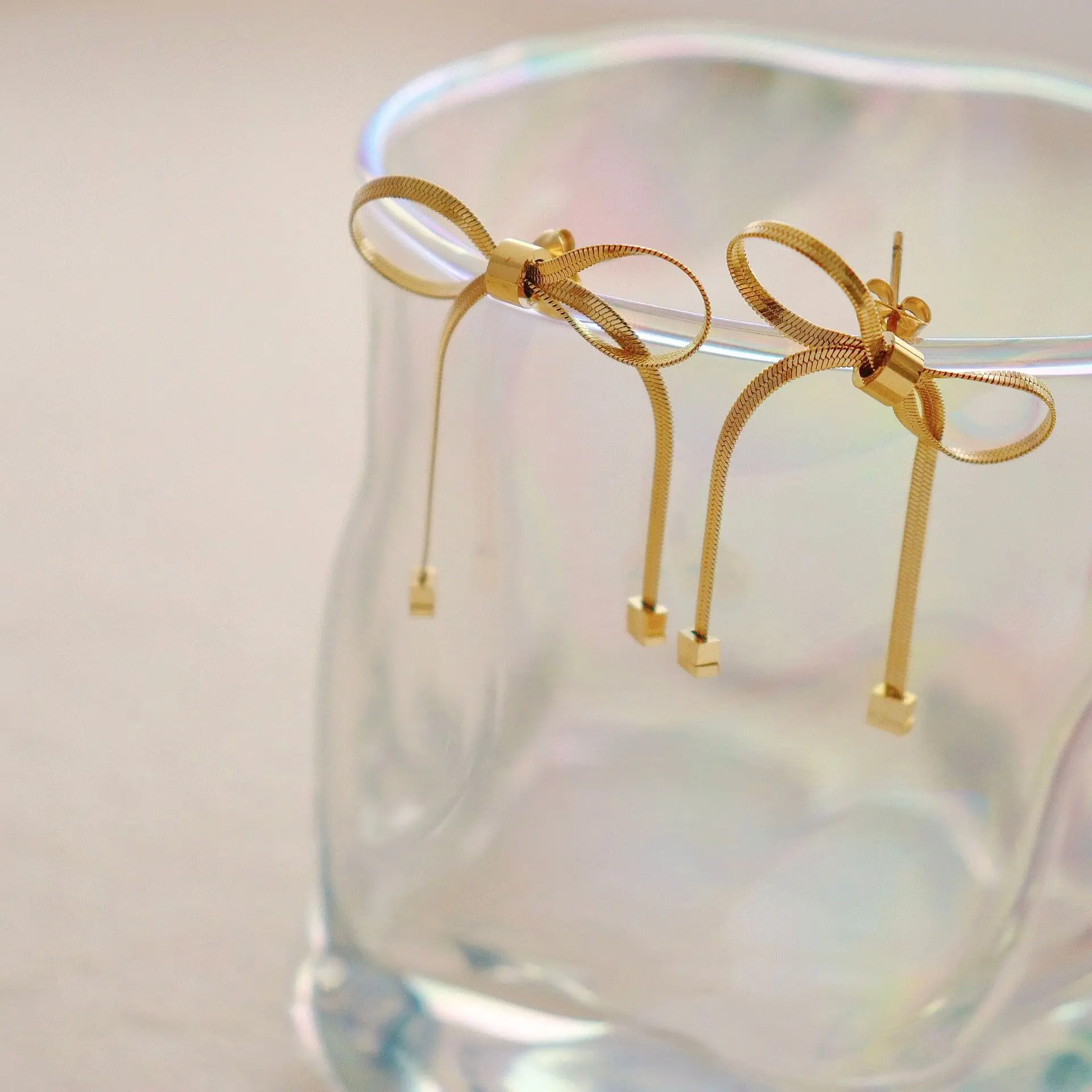 Korean version of ins cold style simple personality niche design female sweet snake chain tie bow stainless steel earrings