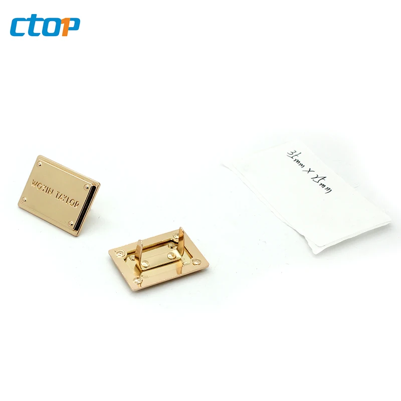 Wholesale standard environmental custom embossed metal logo plate bags metal labels for clothing