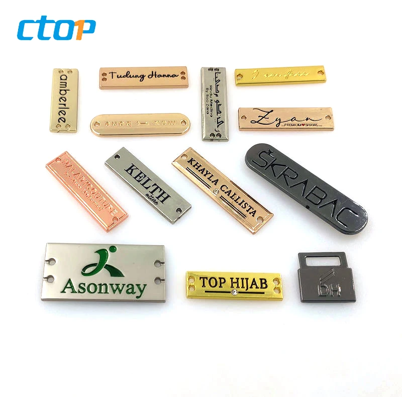 Wholesale standard environmental custom embossed metal logo plate bags metal labels for clothing
