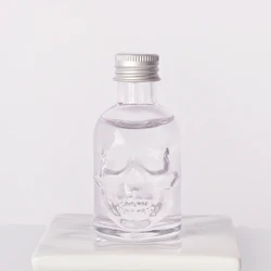 Wholesale 50ml Skull shape small sample alcoholic beverage bottle glass wine bottle with lids