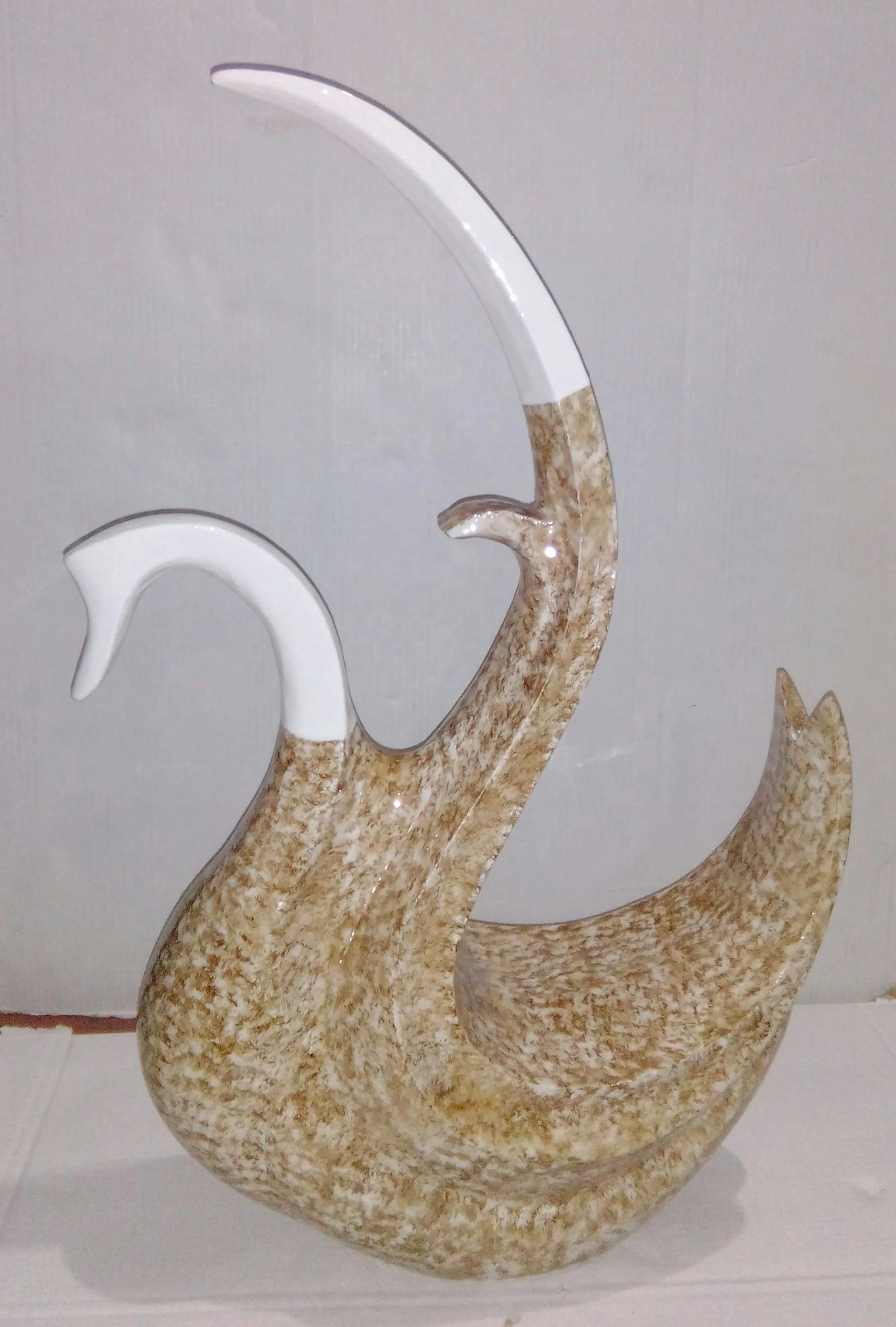 Metal decorative swan in white and golden color .