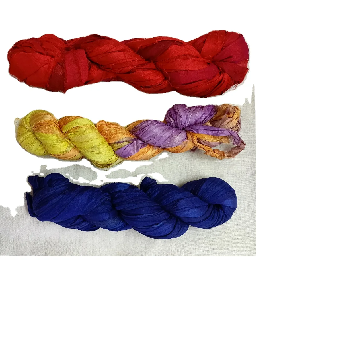 custom made sari silk ribbon yarns in assorted colors made from recycled sari silk fabrics in 100 gram skeins