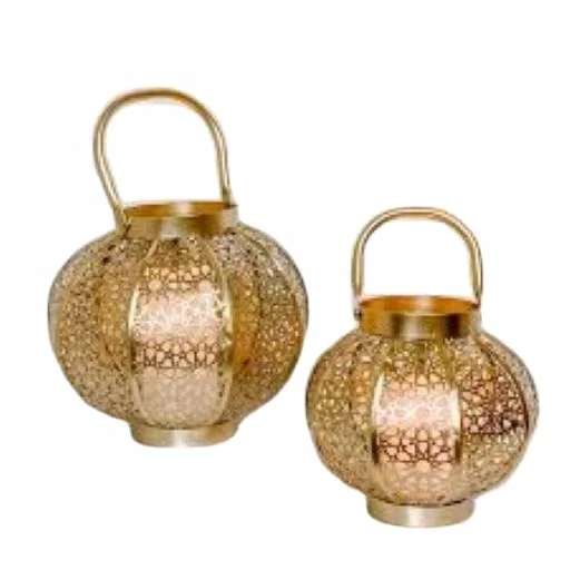 Decorative metal hurricane lantern in golden color in round shape for decoration .