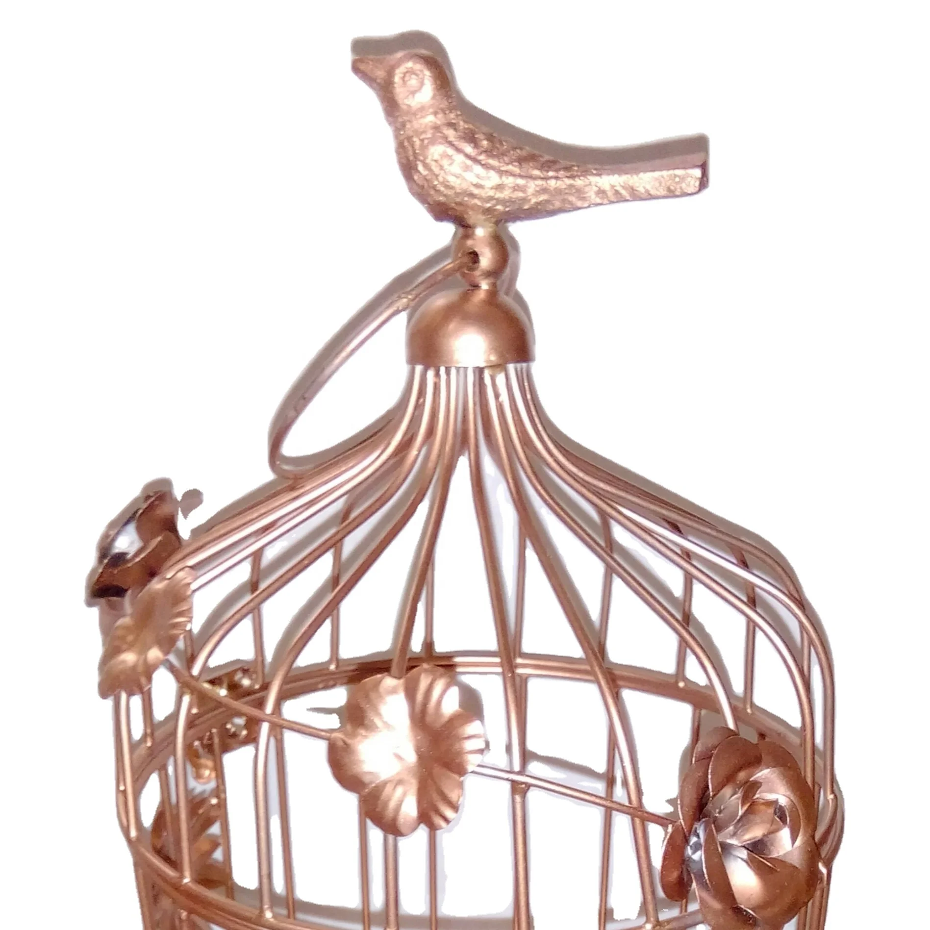 Metal decorative bird cage in rose gold color in bird design .