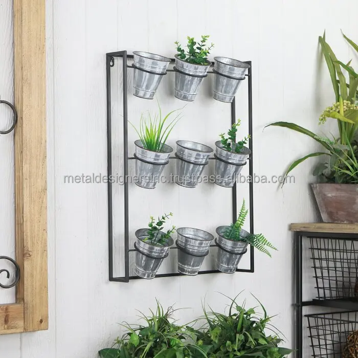 Metal 9 Galvanized planters with black metal stand holding planters for indoor and out door use