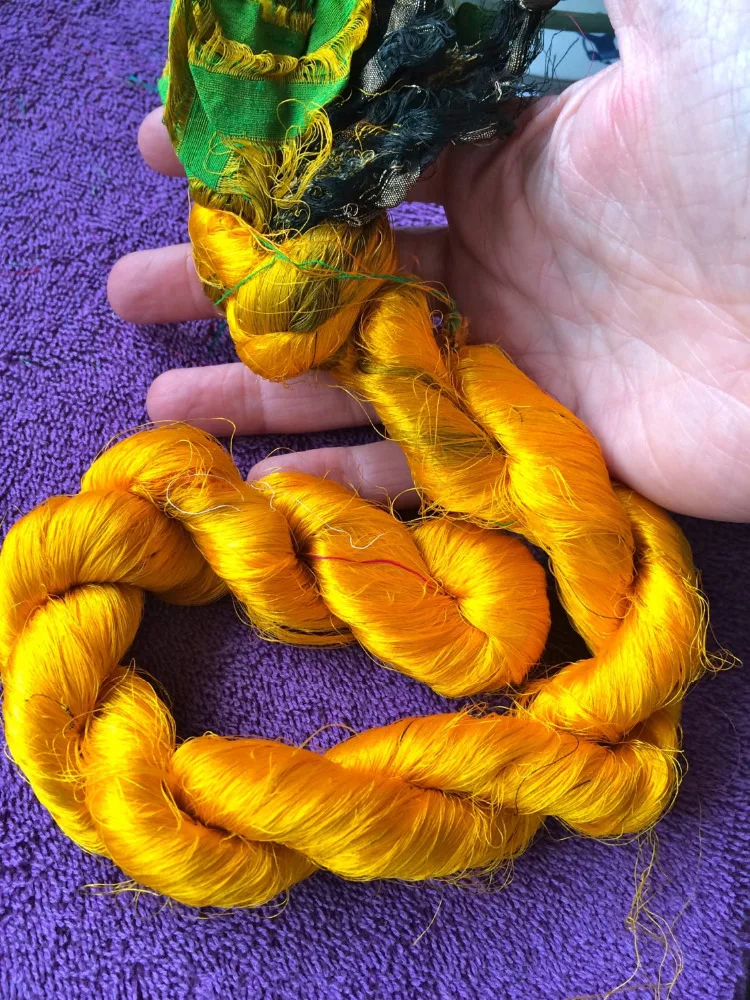 
multi coloured sari silk yarns made from recycled sari silk fibres available in 100 gram skeins suitable for knitters 
